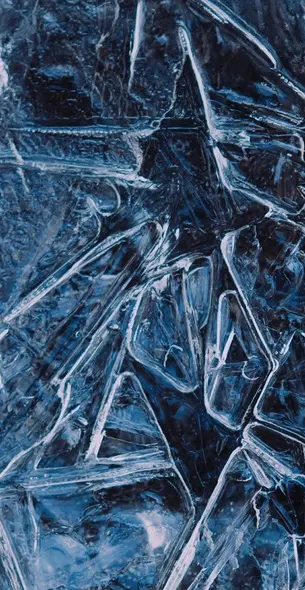 Close-up texture of ice representing IsoGlaze granular de-icer